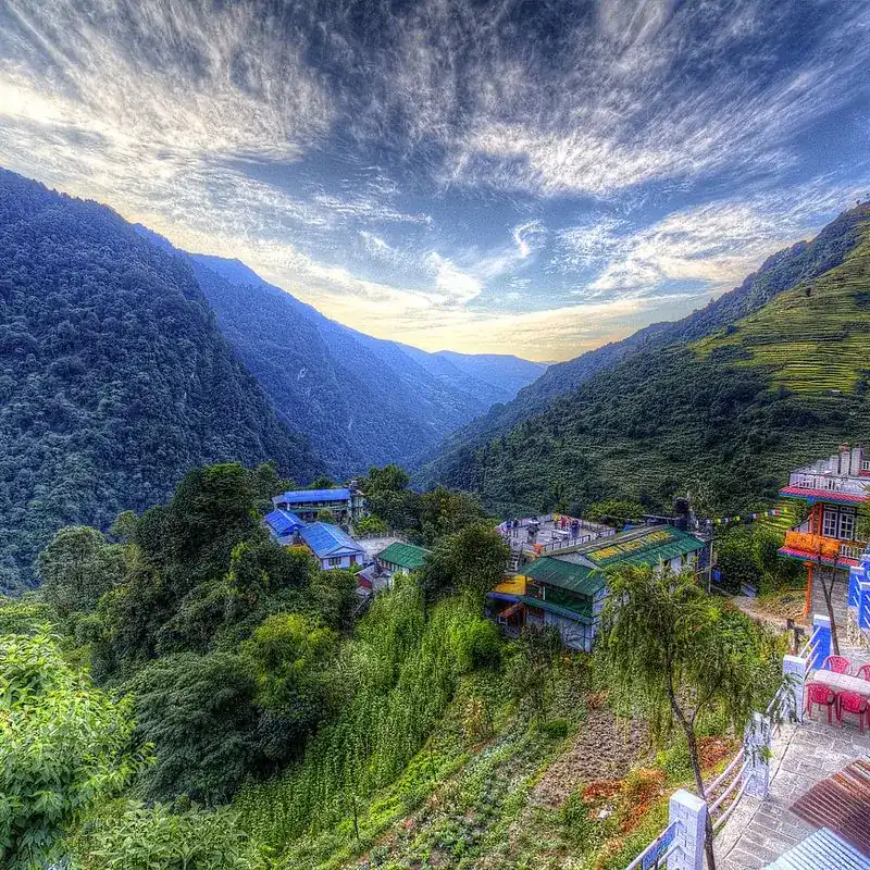 Colorful guest houses and hillside lodges in Jhinu Danda overlooking deep green mountain valleys on the Ghorepani Poon Hill trekking route Nepal.