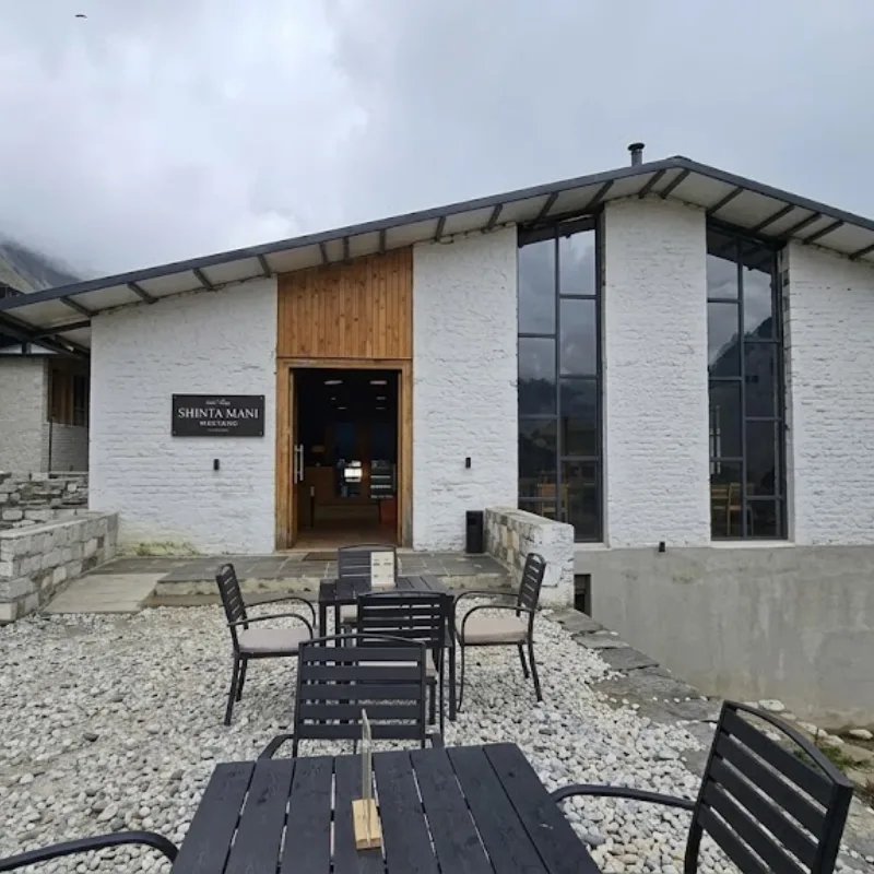 Shinta Mani Mustang luxury boutique resort building with outdoor seating patio and large windows.