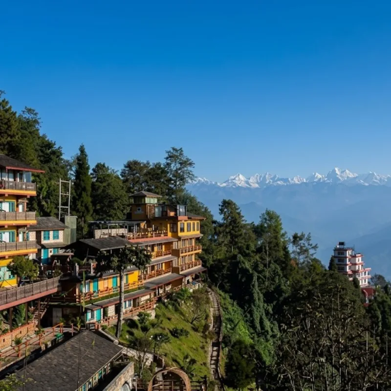 Luxury hillside resort hotel balconies in Nagarkot overlooking snow-capped Himalayan mountain peaks.